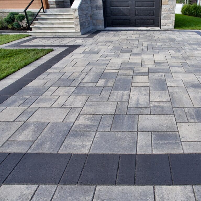 Anthracite and stone block paved driveway installed by MJP Driveways at entrance of modern home in Bournemouth, Dorset